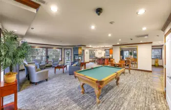 The clubhouse features a large seating area for meetings or gatherings, a pool table, TV, fireplace, games, etc.