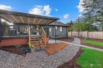 Large covered deck with access to the home from the slider or backdoor to the right.