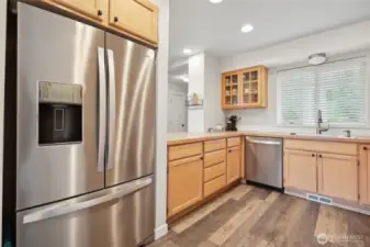 Kitchen features new appliances and glass cabinetry