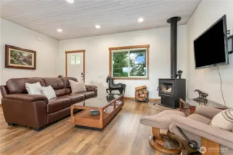 Welcome home to wide plank LVP flooring, 9’ ceilings, and a tongue-and-groove accent ceiling that adds custom character to this inviting space.