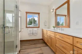 Enjoy a spa-like experience with a glass tile shower, quartz countertops and a large custom vanity. Designed with both luxury and comfort in mind.