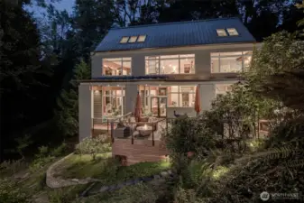 Custom Jim Cutler-designed home in sylvan west-facing setting with 37 feet of private waterfront.