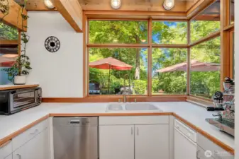 Kitchen includes a separate prep area with ovens, sink, and dishwasher.
