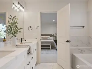 Beautiful dual vanity with quarts counter and Undermount sinks in Primary Bathroom.  Check out the tile floors and tile tub surround.