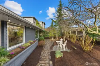 Lovely refreshed front yard with oodles of spaces for your green thumb to thrive!