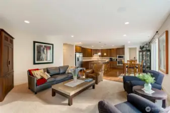 This view captures the true heart of the home — an open-concept design that brings the living room, dining area, and chef’s kitchen together. Perfect for gatherings, this layout allows effortless connection between cooking, dining, and relaxing.
