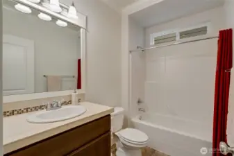 Beautifully maintained full bath on the main level featuring neutral tile, modern lighting, and crisp finishes. Conveniently located near the main floor bedroom or office, ideal for guests or multigenerational living.