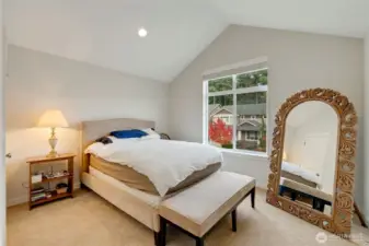 Charming upper-level bedroom highlighted by vaulted ceilings and a large picture window that fills the space with natural light. Offers a lovely view of the neighborhood’s tree-lined street and seasonal color.