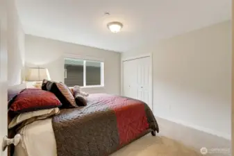 Comfortable secondary bedroom featuring large windows and a generous closet. Its simple design offers flexibility for use as a guest room, nursery, or creative space.
