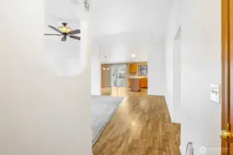 As you come in the front door, there's a coat closet to your right. There's laminate vinyl flooring into the kitchen, but cozy carpet to the left in the living room where you'll also enjoy the ceiling fans!