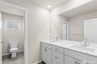 double sinks with a door on the water closet