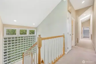 Stairwell to upstairs with 2 bedrooms plus primary with ensuite