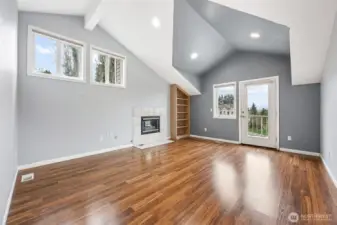 Primary bedroom with gas fireplace and exterior door to top deck. Views of Mt Rainier