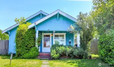 Curb appeal with the large covered porch and mature landscaping