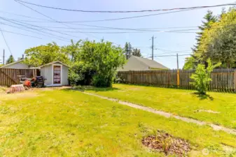 The cement pathway leads to the shed and the rear alley swiing gate