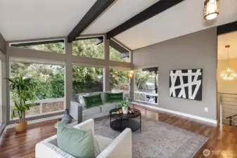Large living room with vaulted ceilings and gorgeous floor to ceiling windows!
