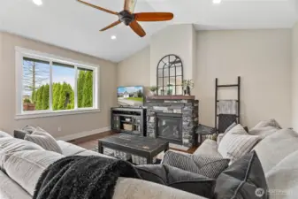 Cozy gas fireplace w/stone surround & nice large window to enjoy private views