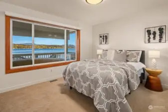 One of 3 ample lower level bedrooms.  This one enjoys an outdoor deck nearby and stellar lake views.
