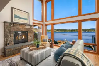 Sun Valley inspired fireplace anchors the main great room with soaring ceilings and panoramic views. Enjoy the thrill of watching Sammamish Rowing Club cruise/crews by from your front room or deck!