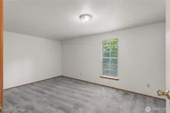 The bedroom on the upper level of Unit A. It includes a large closet.