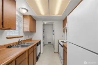 The kitchen open to the utility/laundry room with water heater and hookups for washer and dryer.