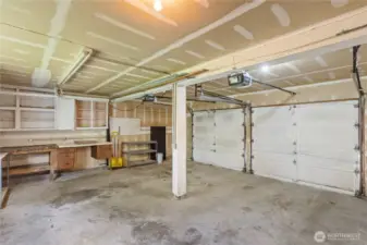 Two car garage with storage space and door openers.
