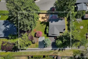 From above, you can see the house, front driveway, RV parking pad, octagonal flower bed, woodchip area, back patio and deck. This angle shows where the larger trees are, at the outside edges of the property. What's not to love?
