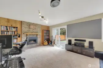 Daylight basement family room with built in projector. Gas fireplace.