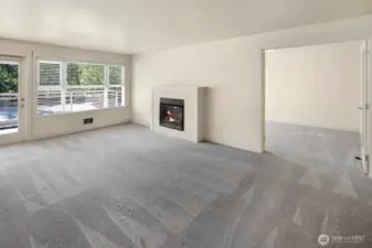Light filled living room with French doors leading into the den