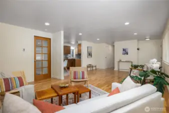 A great room style, the living room flows into the dining room and kitchen. Through the glass door is another room that would make a great private office. It also gives access to the back yard.