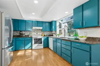 Bold turquoise cabinets add a modern touch.