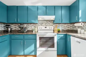 Updated stainless and white appliances complement the modern kitchen design.