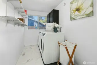 Spacious laundry with storage and natural light.