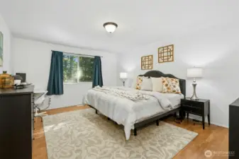 Peaceful primary suite with serene tree-lined views.