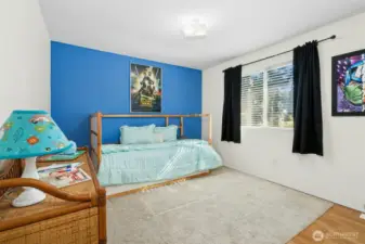Charming bedroom with playful color tones and bright windows.