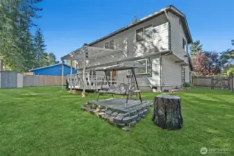 Enjoy year-round outdoor living with a covered deck and open lawn.