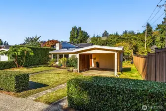 Carport is wide and walk to the front door is mostly covered.  Long driveway offers additional off-street parking.