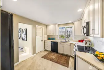 Kitchen was remodeled during ownership.  There is so much storage and counter space in this light and bright room. Closed door opens to utility room.