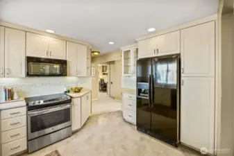 Pantry storage to the right of the refrigerator.  Hall area to the bedrooms and bath is wide and has both a linen and storage closet.
