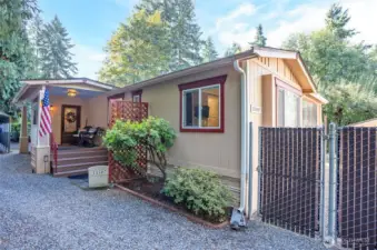 This view showcases the charming front covered porch - Welcome Home!