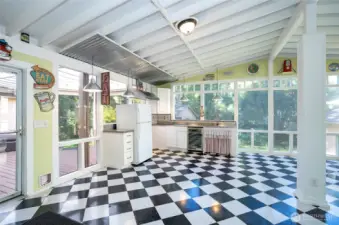 Covered and enclosed entertaining space with kitchenette—perfect for hosting gatherings.