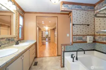 Spacious primary ensuite boasting dual sinks, extended counter space, and a stunning soaking tub.