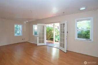 Enter through the French doors into the shop/flex room.