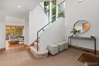 Tiled entry with an open staircase to the second floor.