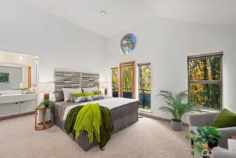 Primary bedroom is wonderfully secluded with a tree house feel.