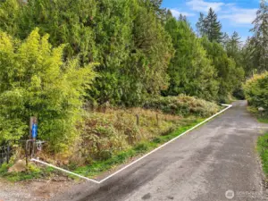 Another close approximation of the frontage along Olympus Beach Road photographed from the North facing South.  The address you see on the post references the neighbor's address to the left.