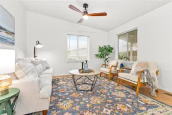 Vaulted living room w/ceiling fan & lots of natural light