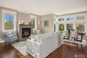 The main level features an open-concept living, kitchen, dining great groom with beautiful, wood floors, large windows for lots of natural light, and a cozy propane fireplace.