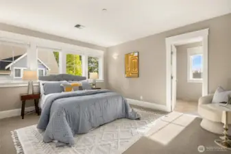 The upper-level primary bedroom suite is spacious and bright with a deep closet (not shown) and an ensuite bathroom.