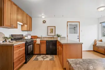 The kitchen has beautiful cherry shaker cabinets and a built-in nook for a table, or the kitchen can be expanded.